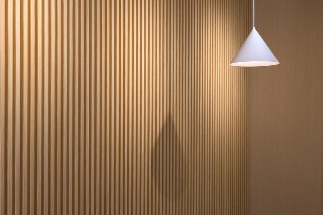 Vertical wood slat wall with a hanging pendant light